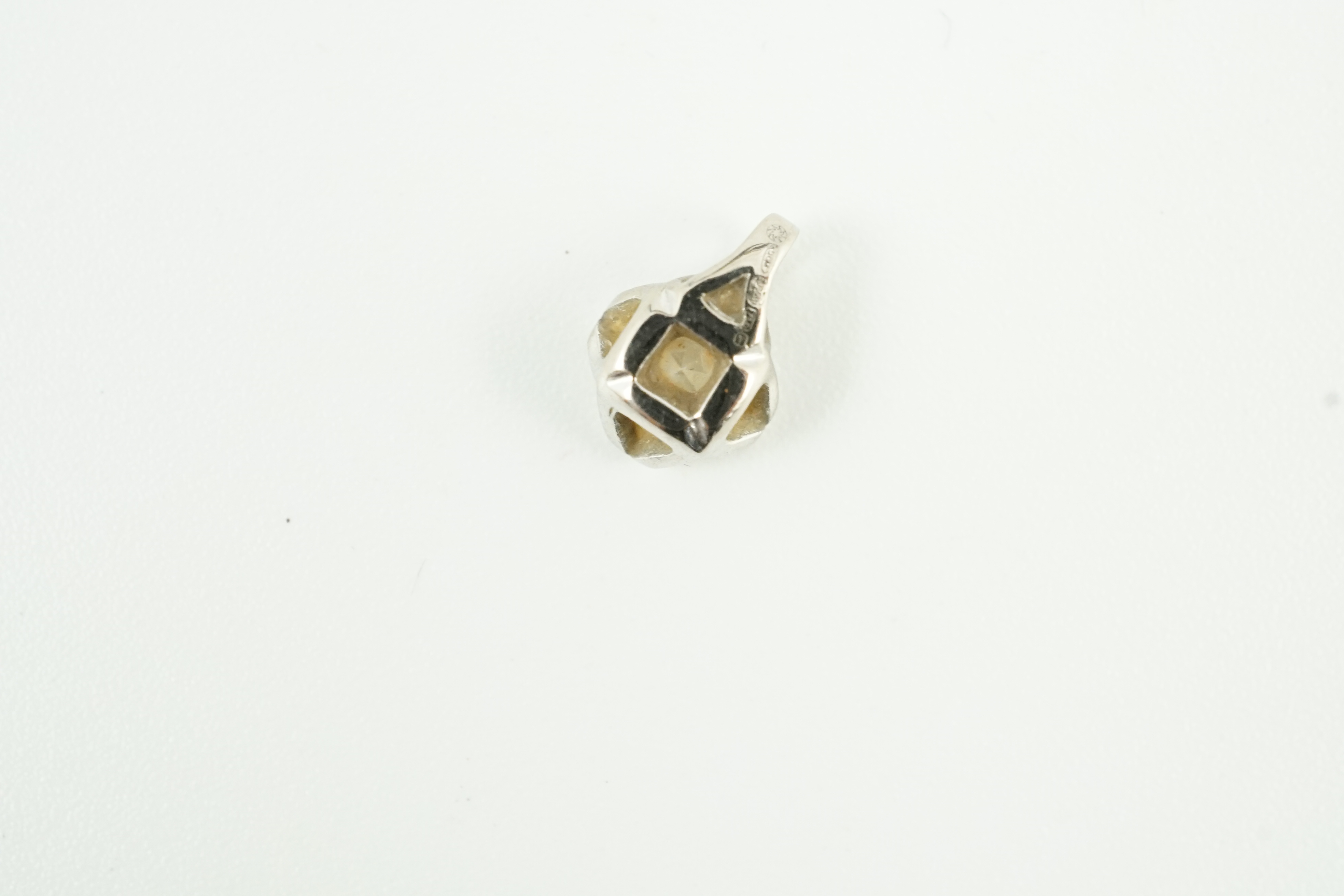 A modern 18ct white gold and solitaire diamond set pendant, gross weight 0.4 grams, stone diameter 5.1mm.